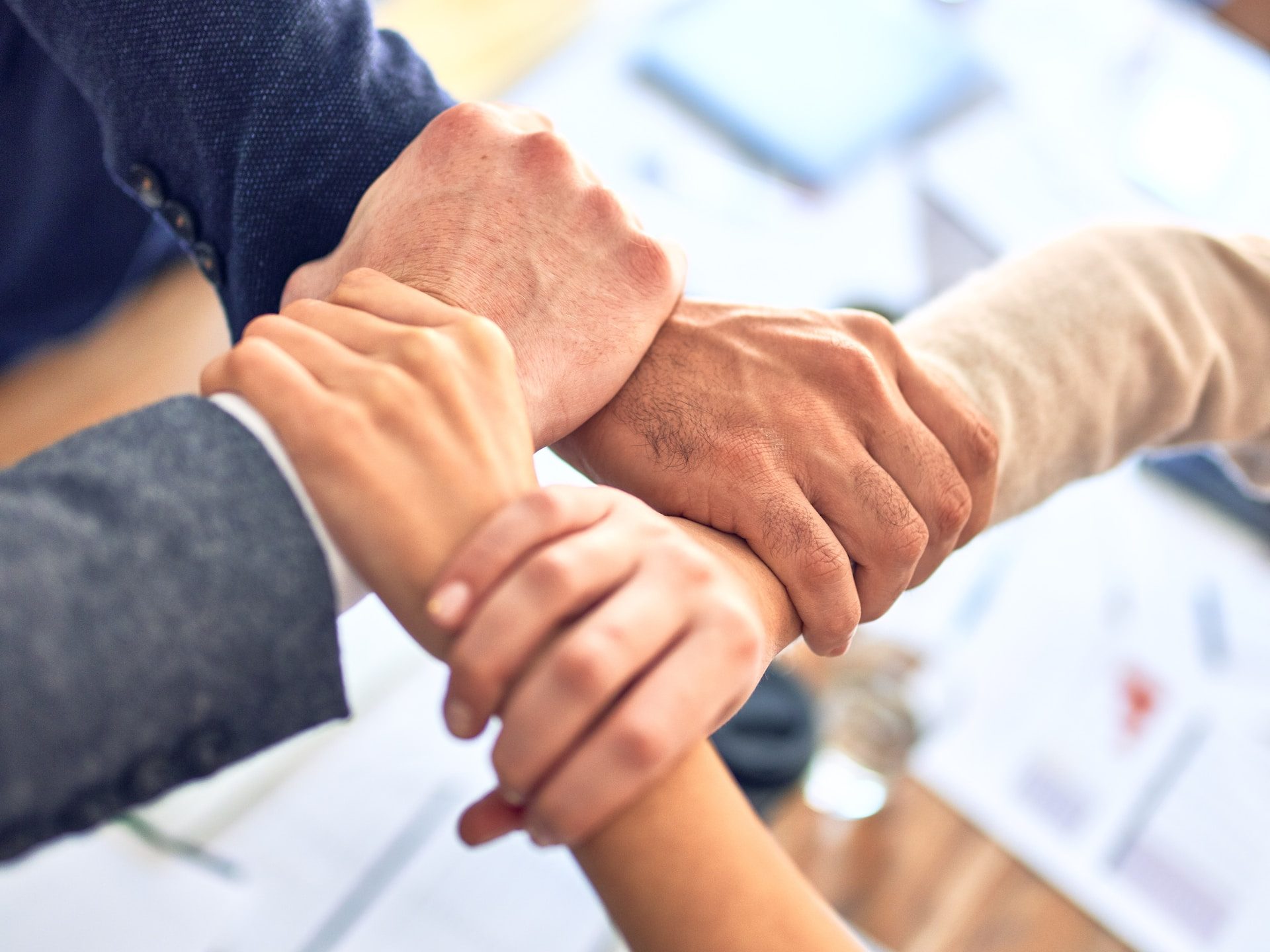 person in black long sleeve shirt holding persons hand